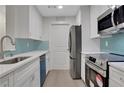 Renovated kitchen with stainless steel appliances and blue accents at 1412 Tuxworth Cir, Decatur, GA 30033