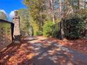 Gated entrance with stone pillars and autumn leaves on the ground at 2812 Highway 16 E, Sharpsburg, GA 30277