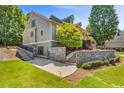 Rear exterior of home with stone foundation, two-tone paint and landscaped yard at 1004 Fairway Seven, Villa Rica, GA 30180