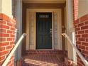 Dark-colored front door with sidelights and a brick walkway at 2119 Gorman Se Grv # 126, Atlanta, GA 30316