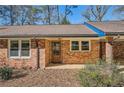 Brick facade with a wooden front door and window at 2328 Melinda Ne Dr, Atlanta, GA 30345