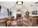 Bright living room with high ceiling, brick fireplace, and stylish decor at 300 Huntington St, Covington, GA 30016