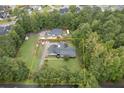 Aerial view of a house with a large backyard and surrounding trees at 36 Lakeshore Dr, Temple, GA 30179