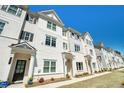 Row of townhouses, white with gray accents, and a grassy area at 1756 Evenstad Way, Smyrna, GA 30080