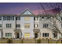 Attractive three story townhome at dusk with warm lighting at 1756 Evenstad Way, Smyrna, GA 30080