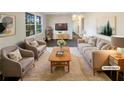 Virtually staged living room featuring beige sofas, a coffee table, and dark hardwood floors at 6257 Castlewood Dr, Morrow, GA 30260