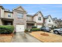 Charming townhome with brick and siding exterior, attached garage, and well-maintained landscaping at 1328 Stone Bay Sw Dr, South Fulton, GA 30331