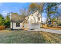Two-story house with white siding, new garage door, and stone accents at 2473 Baker Rd, Atlanta, GA 30318