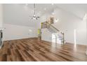 Open living area featuring hardwood floors, high ceilings, and a fireplace at 2473 Baker Rd, Atlanta, GA 30318