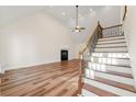 Spacious living room with vaulted ceiling, fireplace, and hardwood floors at 2473 Baker Rd, Atlanta, GA 30318