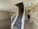 Entrance with staircase leading upstairs, view of kitchen and living room at 1402 Chelsea Downs Ne Ln, Conyers, GA 30013