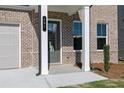 Inviting front entry with dark gray door and white columns at 126 Kingsley Way, Acworth, GA 30102