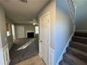 Bright entryway with stairs, coat closet, and view of living room at 916 Brisley Cir, Hampton, GA 30228