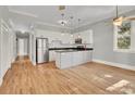 Open concept kitchen with island and hardwood floors at 935 Piedmont Ave # 201, Atlanta, GA 30309