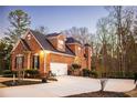 Brick home with attached garage and large driveway at 340 Huiet Dr, Mcdonough, GA 30252