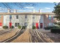 Row of townhouses with red doors and neat landscaping at 992 Old Holcomb Bridge Rd Rd, Roswell, GA 30076