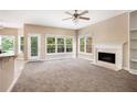 Bright living room featuring a fireplace and access to a deck at 1166 Fords Lake Nw Pl, Acworth, GA 30101