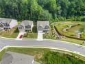 Aerial view of two houses on a tree-lined street in a neighborhood at 1805 Wellston Dr, Lawrenceville, GA 30043