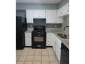 Updated kitchen with granite countertops and black appliances at 6622 Wellington Sq, Norcross, GA 30093