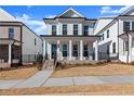 Two-story home with white siding, brick accents, and a front porch at 124 Stonehouse Dr, Cumming, GA 30040