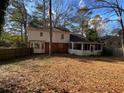 Spacious backyard with a screened porch and wooden privacy fence at 1193 Kelton Dr, Stone Mountain, GA 30083