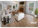 Bright living room with brick fireplace, lots of seating, and ample natural light at 2082 Rainbow Dr, Snellville, GA 30039