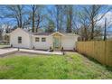 Charming renovated home with light teal door and a wooden fence at 1685 Harbin Sw Rd, Atlanta, GA 30311