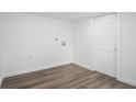 Clean laundry room with gray vinyl flooring, white door, and washer/dryer hookups at 1685 Harbin Sw Rd, Atlanta, GA 30311