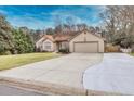 House exterior showcasing a two-car garage and front yard at 2129 Lakeland Ct, Dacula, GA 30019