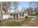 House exterior featuring a two-car garage and a landscaped yard at 1203 Sandune Dr, Norcross, GA 30093