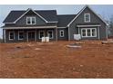 Gray farmhouse with covered porch, unfinished landscaping at 1330 Temple Draketown Rd, Temple, GA 30179