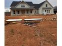 Newly constructed farmhouse with gray siding and black roof at 1330 Temple Draketown Rd, Temple, GA 30179