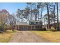 Beautiful home with a blend of brick and siding, a driveway, and a picturesque lawn at 201 Nouveau Sw Ct, Lilburn, GA 30047