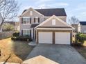 Two-story house with a two-car garage and a front yard at 11602 Kades Trl, Hampton, GA 30228