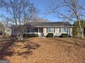 Charming single-story home featuring a well-maintained lawn and mature trees at 1349 Highway 81 E, Mcdonough, GA 30252