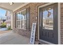 Dark brown front door with sidelights and a welcome sign at 686 Westmoreland Ln, Lawrenceville, GA 30043