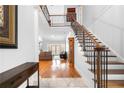 Two-story entryway with hardwood floors, and elegant staircase at 3280 Stillhouse Se Ln # 410, Atlanta, GA 30339