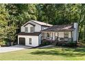 Two-story house with white siding, dark trim, and a two-car garage at 124 Cagle Way, Hiram, GA 30141