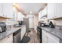 Modern kitchen featuring granite countertops and stainless steel appliances at 1276 Westover Nw Trce, Acworth, GA 30102