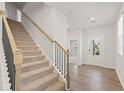 Modern staircase with metal railing and carpeted steps at 7083 Brushwood Bend (Lot 52), Lithonia, GA 30058