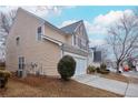 Side view of the house showcasing the beige vinyl siding and the garage at 3335 Briaroak Dr, Duluth, GA 30096