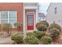 Red front door entrance with manicured shrubs and walkway at 3335 Briaroak Dr, Duluth, GA 30096