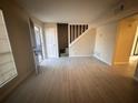 Spacious living room with gray tile floors and view of staircase at 1168 Dogwood Nw Ct, Conyers, GA 30012