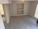 Living room with gray tile floors and built-in shelving unit at 1168 Dogwood Nw Ct, Conyers, GA 30012
