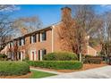 Attractive brick townhomes featuring mature landscaping and a well-maintained exterior at 1094 Old Roswell Rd, Roswell, GA 30076