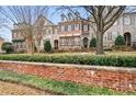 Townhome complex with a brick wall and neatly trimmed shrubs at 2344 Saint Davids Nw Sq # 2, Kennesaw, GA 30152