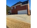 Brick house with a white garage door and a screened porch at 240 Flowers Cove Ln, Lilburn, GA 30047