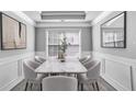 Elegant dining room with marble table, six chairs, and large windows at 4115 Brightmore Dr, Austell, GA 30106