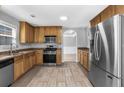 Kitchen with wood cabinets, stainless steel appliances, and tile floor at 4115 Brightmore Dr, Austell, GA 30106