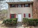 Inviting two-story home with red shutters, a white front door, and a neatly landscaped front yard at 6354 Shannon Pkwy # 2A, Union City, GA 30291